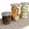 Transparent Glass Jars with Silver Lids Storing Coffee Beans Crackers and Pasta on Wooden Countertop