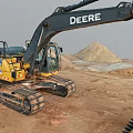 DEERE Yellow Excavator Working On Construction Site With Dirt Ground And Soil Pile