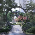 Rockery Stones In Traditional Chinese Garden With Stone Bridge Bamboo And Red Maple Trees