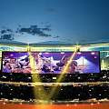 Sports Fitness Live Broadcast On Giant Screen With Bright Lighting In Evening Stadium