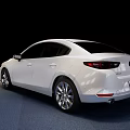 White Mazda Sedan Featuring Modern Sleek Body And Alloy Wheels On Blue