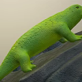 Green Lizard Perched On A Rocky Surface With Fresh Green Leaves