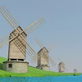 Row of Traditional Wooden Windmills With Large Rotating Blades Stone Bases and Green Hillside