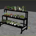 Black Multi tiered Flower Stand With Wheels Holding Various Potted Plants