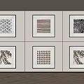 Six Black And White Framed Artworks On Wall With Herringbone Wooden Floor