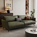 Modern Green Leather Sofa With Plaid And Brown Cushions And Round Coffee Table