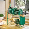 Golden Kitchenware Organizer with Green Black Plates Cups Spatulas and Transparent Kettle