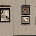 Wall Decor With Various Patterned Paintings And Wall Light In Beige Room