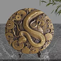 Brass Circular Decorative Ornament Set Featuring Snake And Coin Patterns On Marble Tabletop