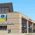 Modern Commercial Complex With Glass Facade Starbucks Coffee And PRADA Stores