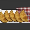 Golden Fried Dumplings Served On White Plate With Red And White Checkered Napkin