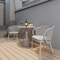 Modern Rattan Outdoor Patio Table and Chairs Set With Wine Bottle Glasses and Fruit Plate