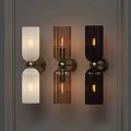Three Modern Wall Lamps With Ribbed Glass Shades And Brass Bases On Grey Wall