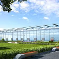Modern Industrial Factory Building With Glass Curtain Walls Metal Roof And Green Surroundings