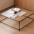 Modern Coffee Table with Glass Top Black Metal Frame and Books Camera in Living Room