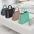 Stylish Leather Handbags In Various Colors Placed On White Bench In Bedroom