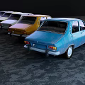 Various Colored Vintage Cars Lined Up On Road With Hills And Tower Background