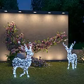 Outdoor Night Decorative Scene With Lighted Deer Ornaments And Flower Wall On Lawn