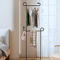Modern Clothes Rack With Hanging Clothes Handbag And Plaid Blanket In Bedroom