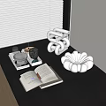 White Inflatable Decorative Ornament On Black Table With Open Book Cups And Books