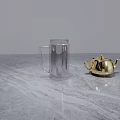Transparent Glass Mug With Handle On Marble Countertop And Gold Accessory
