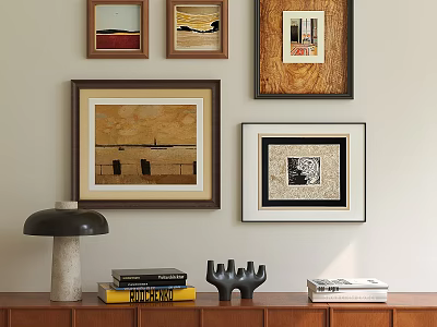 Framed Oil Paintings on Wall Above Wooden Cabinet with Books and Decorative Lamp 3d model
