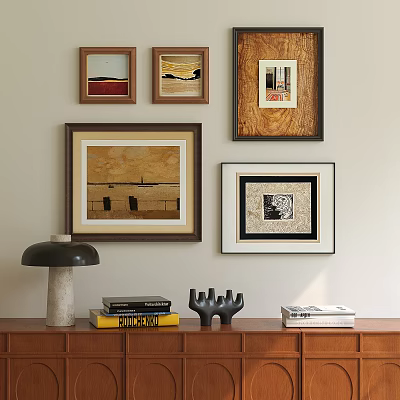 Framed Oil Paintings on Wall Above Wooden Cabinet with Books and Decorative Lamp 3d model