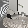 Modern Beige Single Sofa with Black Armrests on Woven Rug Near Window Blinds Small Table Plant and Magazines
