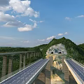 Scenic Mountain Highway Bridge With Tunnel And Forested Surroundings Under Blue Sky