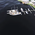 Scenic Marina Dock With Moored Boats And Coastal Houses On Calm Water