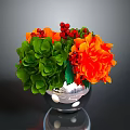 Colorful Flower Arrangement With Green Leaves Orange Blooms And Red Berries In Silver Vase
