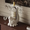Elegant Wine Bottle And Glasses On White Female Sculpture Base With Wooden Table And Wall Decor