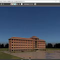 Red Brick Office Building With Multiple Windows Front Plaza Green Plants And Blue Sky