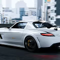 White Sports Car Driving On Urban Road With Sleek Design And Dynamic Rear Spoiler