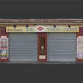 Small Commercial Building with White Roof Red Border Roller Shutters and Tobacco Post Office Signboards