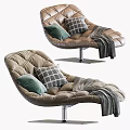 Beige Tufted Lounge Chair With Green And Patterned Cushions And Gray Throw Blanket