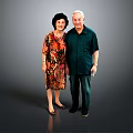 Elderly Man In Dark Green Shirt Standing With Woman In Floral Dress Against Gray Background