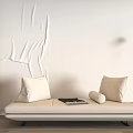 Beige Two-Seater Sofa With Pillows And Magazine By Textured White Wall And Lamp