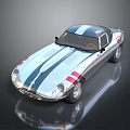 Vintage Silver Sports Car With Blue Center Stripe Red Accents Streamlined Body And Shiny Surface