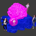 People Interacting With Pink Installation And IBC Amsterdam Logo On Blue Carpet