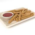 Delicious Crunchy Breadsticks Served With Red Dipping Sauce On Marble Plate
