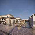 Elegant Commercial Street With White Buildings Outdoor Seating Areas Umbrellas And Store Signs