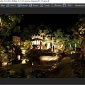 Enchanting Night Scenery with Illuminated Castle Waterfall Wooden Bridge and Lush Trees Garden Lights