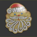 Christmas Themed Santa Shaped Cookie With White Frosting Curls Red Hat Blue Eyes Red Nose