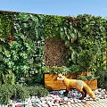 Vibrant Living Plant Wall with Lush Greenery Diverse Plants Wooden Planter Pebbles and Decorative Fox
