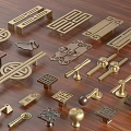 Brass Handles With Various Traditional Patterns And Geometric Shapes On Wooden Surface