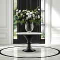 Stylish Entryway With Black Door Marble Vase And White Green Flower Arrangement On Round Table