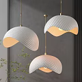 Three White Shell Shaped Pendant Lights With Wavy Texture And Golden Chains Against Gray Wall 3d model