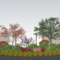 Vibrant Circular Shrub Bed With Colorful Red Purple Yellow Foliage And White Fence Blue Sky