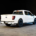 White Modern Pickup Truck With Crew Cab And Black Wheels In Indoor Setting